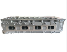 Carica l'immagine nel visualizzatore di Gallery, Silver cylinder head with intake ports and machined valve openings on the side by SUONAMA