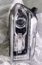 تحميل الصورة في عارض المعرض، Close-up chrome and dark housing vehicle headlight with circular projector lens