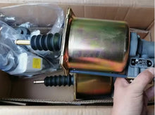 Charger l'image dans la galerie, Clutch booster actuator showing black rubber boots and gold-toned cylinder, hand holding