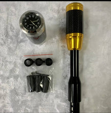 Cargar imagen en el visor de la Galería, Gold shift knob lengthener with clock gauge, carbon-fiber grip, and rubber mounting caps