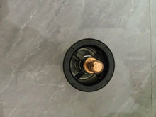 Carica l'immagine nel visualizzatore di Gallery, Automotive thermostat housing with black cover and brass center, top view