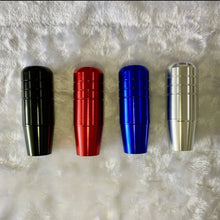 Charger l'image dans la galerie, Four aluminum shift knobs in black, red, blue, and silver with ribbed rings