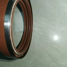 Carregar imagem no visualizador da galeria, Oil seal ring with brown sealing lip and silver metal housing, front view