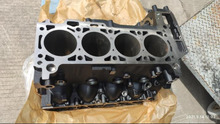 Load image into Gallery viewer, Engine cylinder block on packaging with four cylinder bores and rocker-side parts
