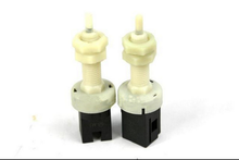 Charger l'image dans la galerie, Pair of stop light switches with white plastic stems and black electrical connector blocks