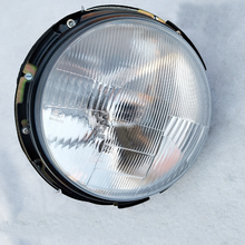 Cargar imagen en el visor de la Galería, LED headlamp with clear lens and black housing, front view with mounting tabs