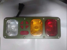Carregar imagem no visualizador da galeria, Rear tail light assembly showing red, amber, and clear lenses with cross-style markers
