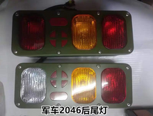 Carregar imagem no visualizador da galeria, Rear tail light assembly with red, amber, and clear rectangular lenses on green panel