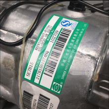 Charger l'image dans la galerie, Air conditioning compressor label on silver housing with green sticker and barcodes.
