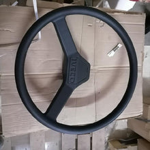 Carica l'immagine nel visualizzatore di Gallery, Black steering wheel with textured grip and central control panel, 3-spoke design
