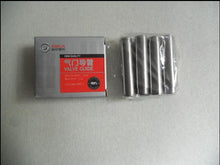 Charger l'image dans la galerie, Valve guide set showing gray package with red label and silver cylindrical guides