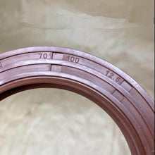 Charger l'image dans la galerie, Front differential oil seal ring close-up showing embossed measurement numbers