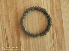 Załaduj obraz do przeglądarki galerii, Synchronizer ring gear laid flat, showing outer teeth and inner ring