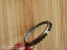 Załaduj obraz do przeglądarki galerii, Synchronizer ring gear, side view showing toothed outer rim and inner ring