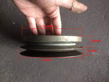 Charger l'image dans la galerie, Metal crankshaft pulley flange with stepped edges on a flat surface