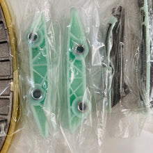 Carica l'immagine nel visualizzatore di Gallery, Timing chain kit includes green chain guides and metal tensioner parts, wrapped in plastic