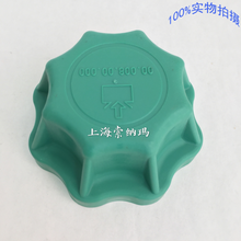 Charger l'image dans la galerie, Green coolant tank cap with embossed arrow icon and grip ridges