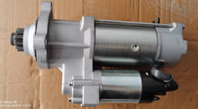 Charger l'image dans la galerie, Starter motor with cylindrical housing, silver-gray finish, side mounting tabs