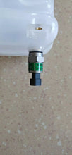 Charger l'image dans la galerie, Close-up of white expansion tank inlet with green-ring sensor and black hose barb