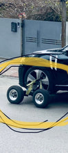 Charger l'image dans la galerie, Four-wheel car dolly under a yellow vehicle, with metal lift arms