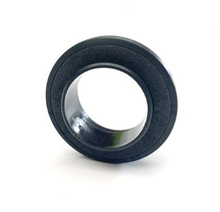 Load image into Gallery viewer, Camshaft oil seal with black rubber edge and metallic inner surface, angled close-up
