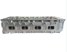 Load image into Gallery viewer, Silver cylinder head with intake ports and machined valve openings on the side by SUONAMA
