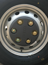 Load image into Gallery viewer, Wheel cover installed on silver rim with black center and gold hub fasteners
