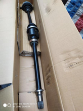 Load image into Gallery viewer, Front drive shaft with two black rubber boots and long metal axle, near end
