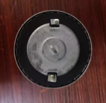 Load image into Gallery viewer, Fuel tank cap top with black outer ring, circular center, and two mounting tabs
